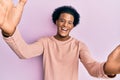 African american man with afro hair wearing casual clothes looking at the camera smiling with open arms for hug Royalty Free Stock Photo