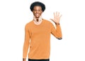 African american man with afro hair wearing cervical neck collar showing and pointing up with fingers number five while smiling