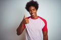 African american man with afro hair wearing red striped t-shirt over isolated white background doing happy thumbs up gesture with Royalty Free Stock Photo