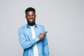 African american man with beard pointing away side with finger isolated over gray background Royalty Free Stock Photo