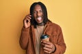 African american man with braids having conversation talking on the smartphone sticking tongue out happy with funny expression Royalty Free Stock Photo