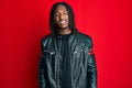 African american man with braids wearing black leather jacket with a happy and cool smile on face Royalty Free Stock Photo