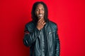 African american man with braids wearing black leather jacket smiling looking confident at the camera with crossed arms and hand Royalty Free Stock Photo