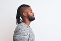 African american man with braids wearing grey sweater over isolated white background looking to side, relax profile pose with Royalty Free Stock Photo