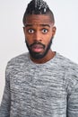 African american man with braids wearing grey sweater over isolated white background scared in shock with a surprise face, afraid Royalty Free Stock Photo