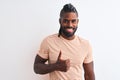 African american man with braids wearing striped t-shirt over isolated white background doing happy thumbs up gesture with hand Royalty Free Stock Photo