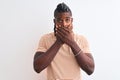 African american man with braids wearing striped t-shirt over isolated white background shocked covering mouth with hands for Royalty Free Stock Photo