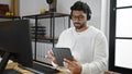 African american man business worker using touchpad and headphones working at office Royalty Free Stock Photo