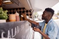 African american man buying wok at food truck Royalty Free Stock Photo