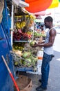 African American man buys coconuts