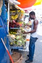 African American man buys coconuts