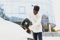 African American man charging his electric car Royalty Free Stock Photo