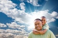 African American Man with Child Over Sky Royalty Free Stock Photo