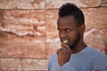 African american man chomping on a bitcoin crypto currency with his teeth in closeup Royalty Free Stock Photo