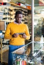 African american man chooses and buys pistol at gun store