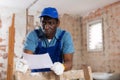 Man construction worker with document inside apartment Royalty Free Stock Photo