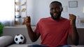 African-american man dancing victoriously, celebrating victory of football team Royalty Free Stock Photo