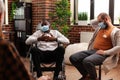 African american man with disability attending aa meeting with people Royalty Free Stock Photo