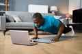 African American Man Doing Online Fitness Pushup Workout