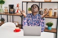 African american man doing yoga exercise sitting on table at home Royalty Free Stock Photo