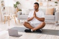 African American Man Doing Yoga Sitting At Laptop At Home Royalty Free Stock Photo