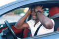 An African-American man driving a car. Human emotions Royalty Free Stock Photo