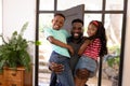 African American man enjoying his time at home and holding his children Royalty Free Stock Photo