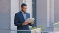 African American man ethnic businessman employer entrepreneur office worker standing on balcony holding day planner