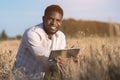 African American man explores huge wheat field smiling Royalty Free Stock Photo