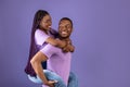 African American man giving piggyback ride for his woman Royalty Free Stock Photo