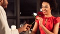 African American Man Giving Rose To Girlfriend In Restaurant, Panorama