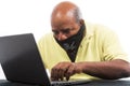 African American Man is hacking a laptop computer wearing a pirate mask