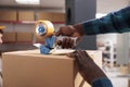 African american man sealing box with packing tape gun Royalty Free Stock Photo