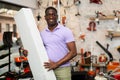 African-american man with box in gardening tools shop Royalty Free Stock Photo