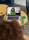 African american man having a video conference on laptop at a bar