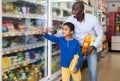African American man with his son making purchases Royalty Free Stock Photo