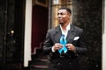 African american man hold blue prostate ribbon. Awareness cancer of men health