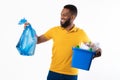 African American Man Holding Garbage Bag And Box, White Background