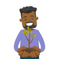 African-american man holding green plant in soil. Royalty Free Stock Photo