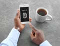 African-American man holding mobile phone with blank screen in hand Royalty Free Stock Photo