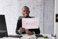 African American Man Holding Open Enrollment Registration