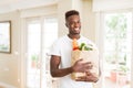 African american man holding paper bag full of groceries happy and smiling confident Royalty Free Stock Photo