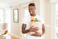 African american man holding paper bag full of groceries happy and smiling confident Royalty Free Stock Photo