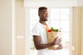 African american man holding paper bag full of groceries happy and smiling confident Royalty Free Stock Photo