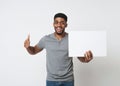 African-american man holding white blank board and showing thumb up Royalty Free Stock Photo