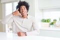 African American man at home smiling doing phone gesture with hand and fingers like talking on the telephone Royalty Free Stock Photo