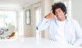 African American man at home smiling doing phone gesture with hand and fingers like talking on the telephone Royalty Free Stock Photo