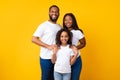 African American man hugging his wife and smiling daughter Royalty Free Stock Photo