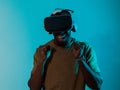 African American man immerses himself in a thrilling horror gaming experience using VR glasses, creating an isolated and