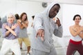 African American man learning to dance krump with group Royalty Free Stock Photo